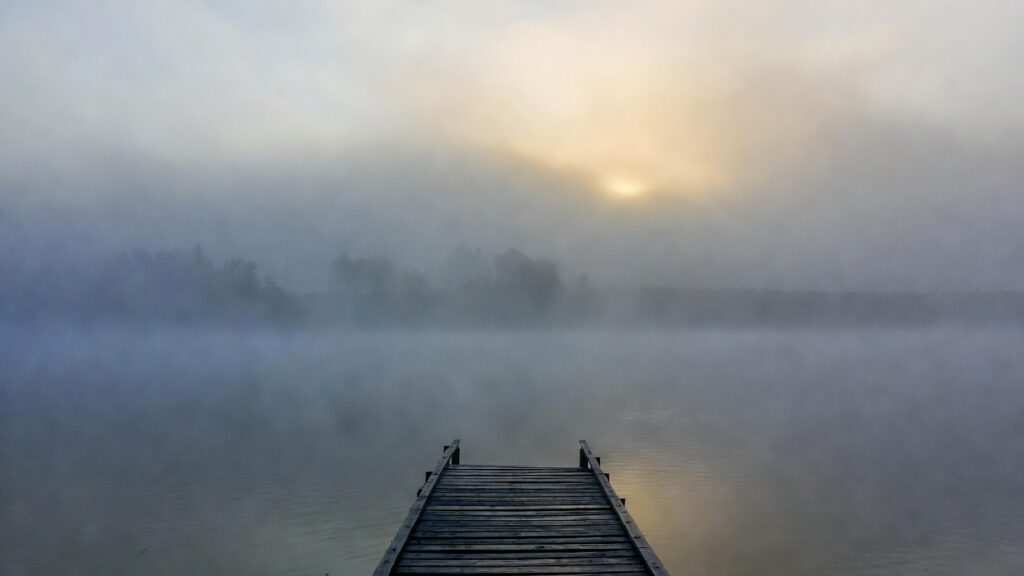 Foggy lakeside pier illustrating depersonalisation and derealisation in dissociative PTSD subtype diagnosis